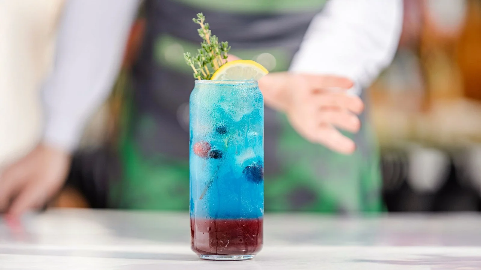 A bartender presents a summer cocktail